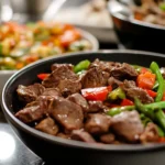 A selection of beef dishes, including stew, stir-fry, and salad, displayed on a modern kitchen countertop